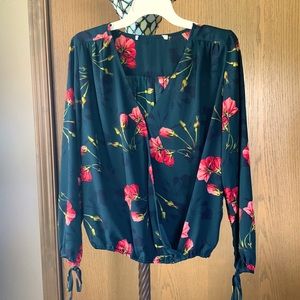 Blue/green women’s long sleeve blouse. Fitted at bottom. Ties at sleeves.